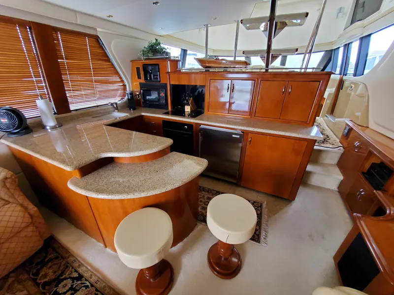 Slide: The Image of Luxurious interior of 2003 Carver 570 Voyager Pilothouse yacht with modern kitchen. - 35