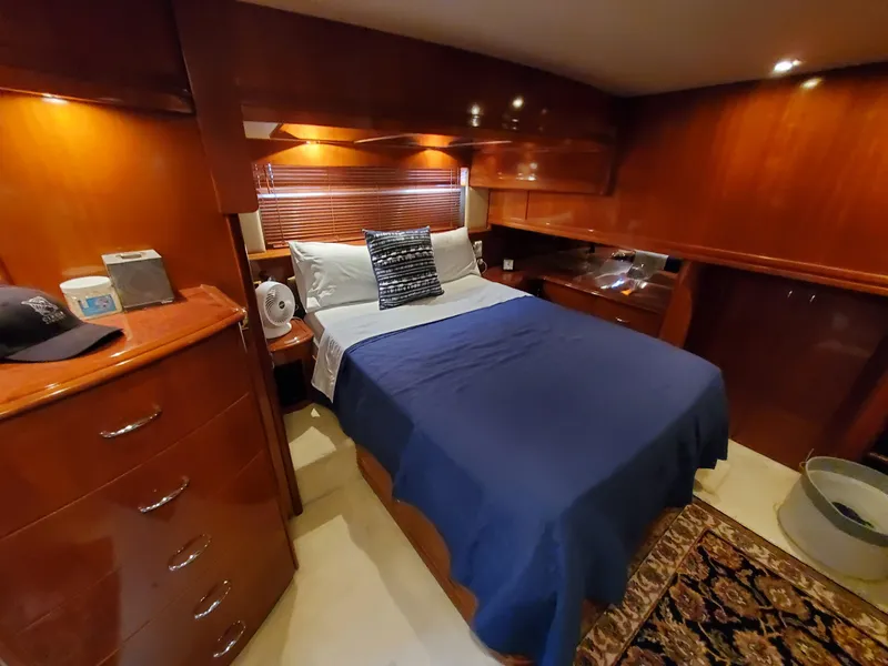 Slide: The Image of Luxurious bedroom in 2003 Carver 570 Voyager Pilothouse yacht with wooden cabinetry. - 41