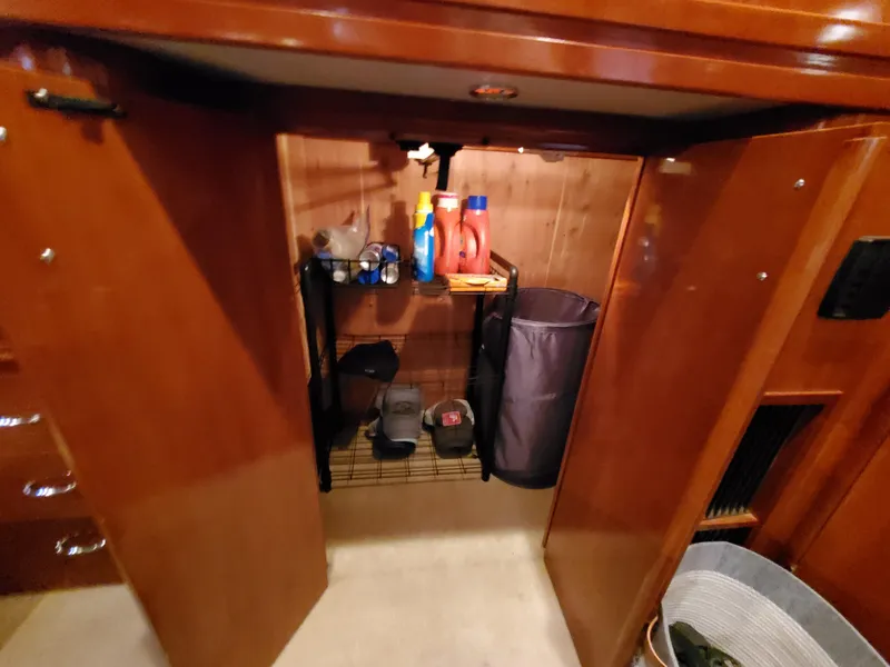Slide: The Image of Open closet in 2003 Carver 570 Voyager Pilothouse with cleaning supplies and storage. - 43