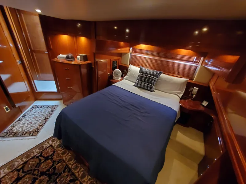 Slide: The Image of Luxurious bedroom in 2003 Carver 570 Voyager Pilothouse yacht with wood paneling and cozy bedding. - 44