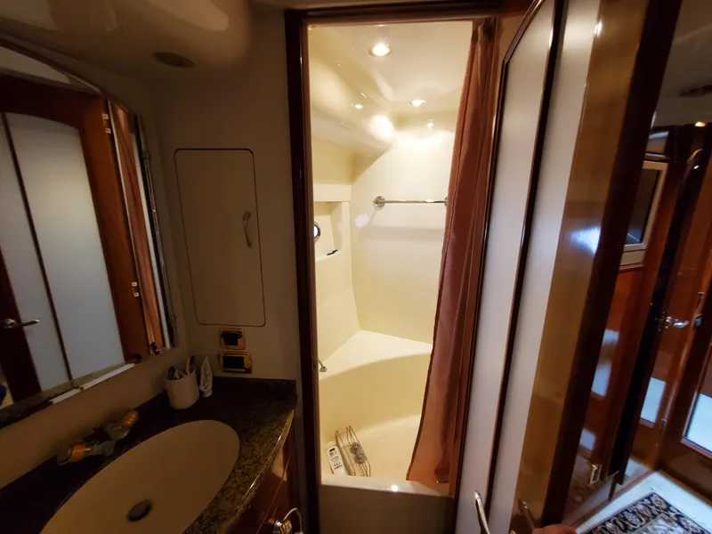 Slide: The Image of 2003 Carver 570 Voyager Pilothouse bathroom with sink, mirror, and shower. - 46