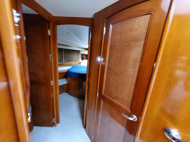 Slide: The Image of Interior of 2003 Carver 570 Voyager Pilothouse with wooden doors and cozy bedroom. - 48