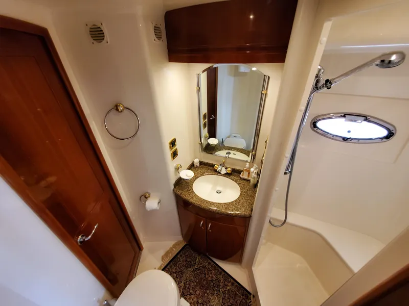 Slide: The Image of 2003 Carver 570 Voyager Pilothouse bathroom with sink, mirror, and shower. - 49