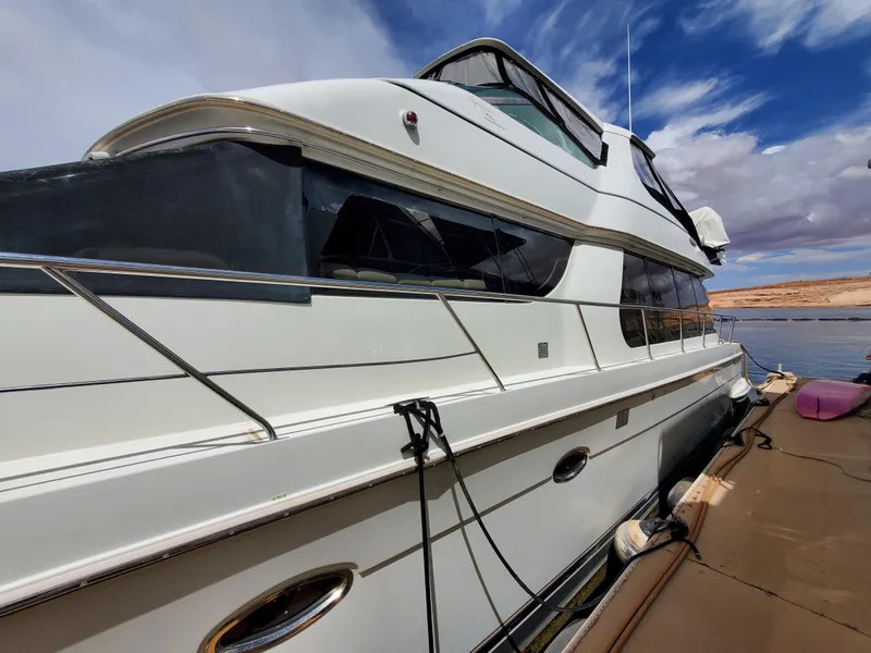 Slide: The Image of 2003 Carver 570 Voyager Pilothouse yacht docked on a sunny day. - 6