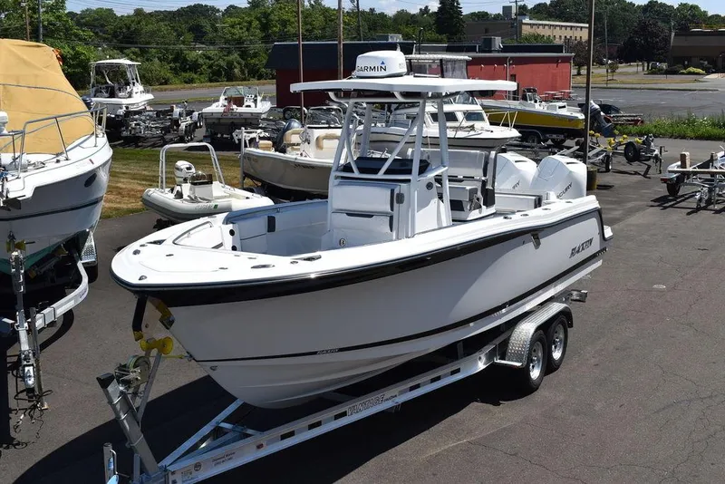 The Image of 2023 Blackfin 252CC center console boat on a trailer in a marina. - 0