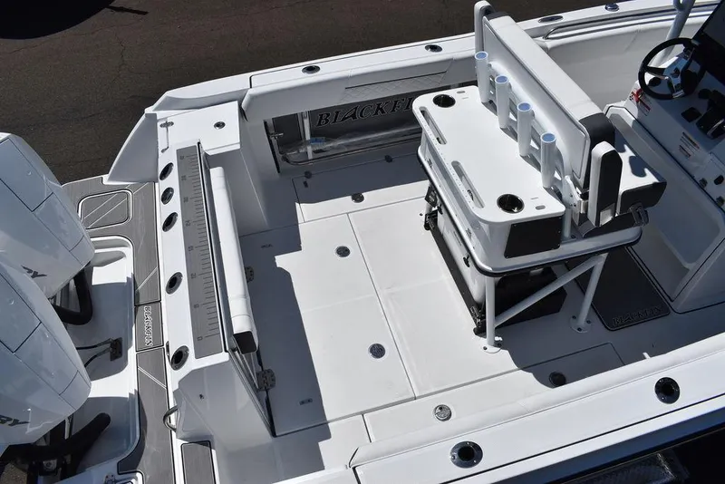 Slide: The Image of 2023 Blackfin 252CC boat deck with seating and dual engines. - 10