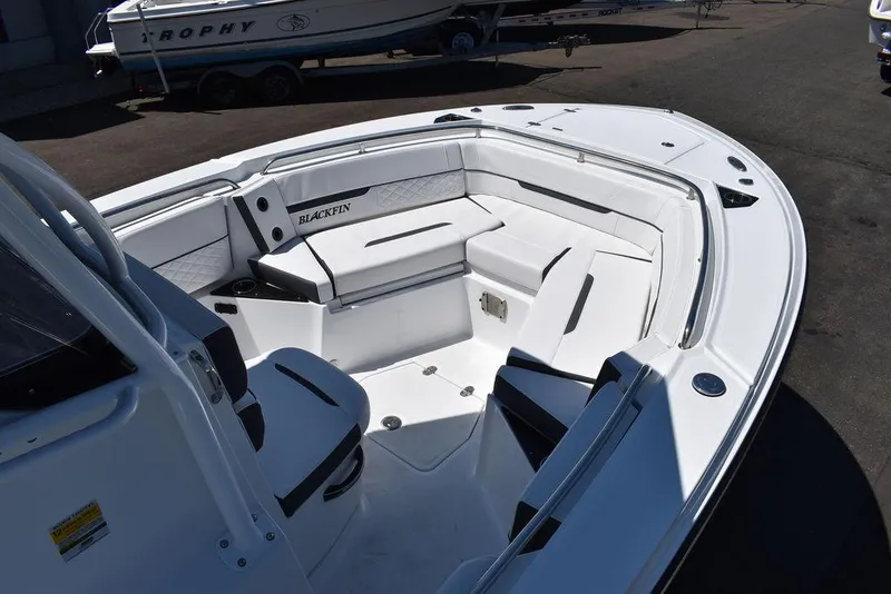Slide: The Image of 2023 Blackfin 252CC boat interior with white seating and ample storage. - 12
