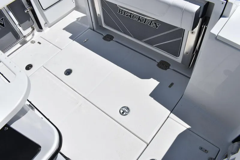 Slide: The Image of 2023 Blackfin 252CC boat deck with storage compartments and seating. - 16