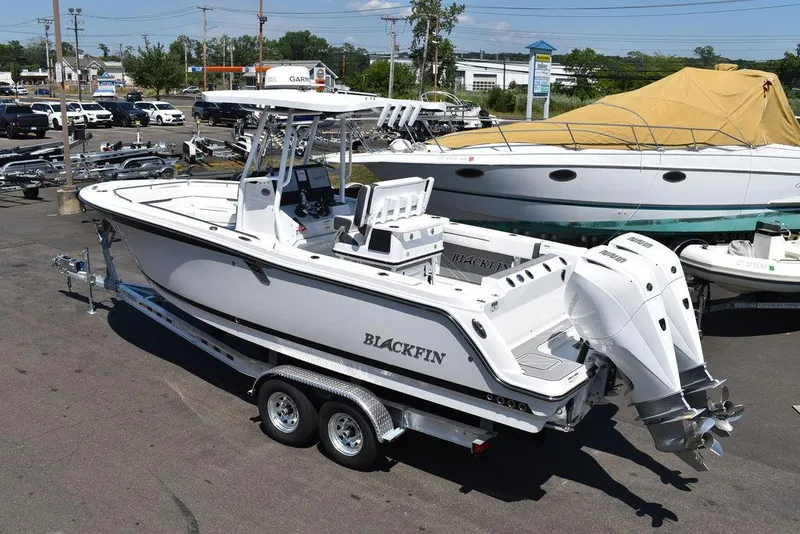 Slide: The Image of 2023 Blackfin 252CC boat on a trailer in a marina. - 3