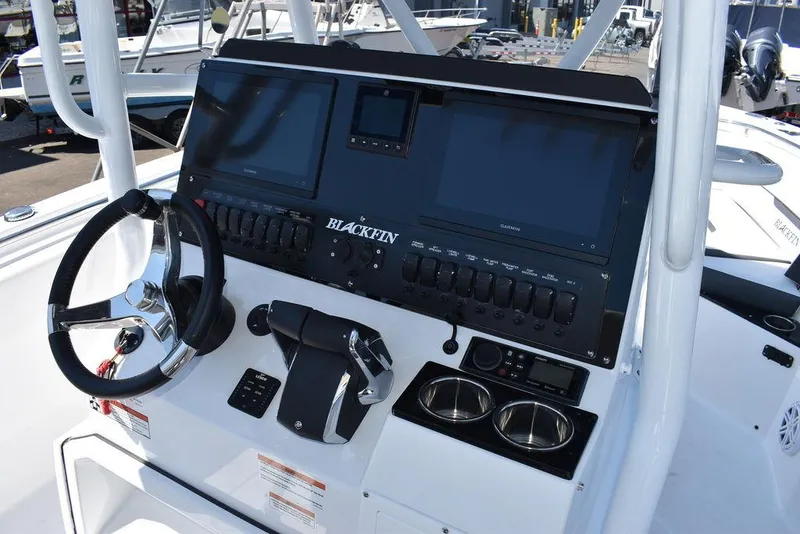 Slide: The Image of 2023 Blackfin 252CC boat console with dual screens and steering wheel. - 33