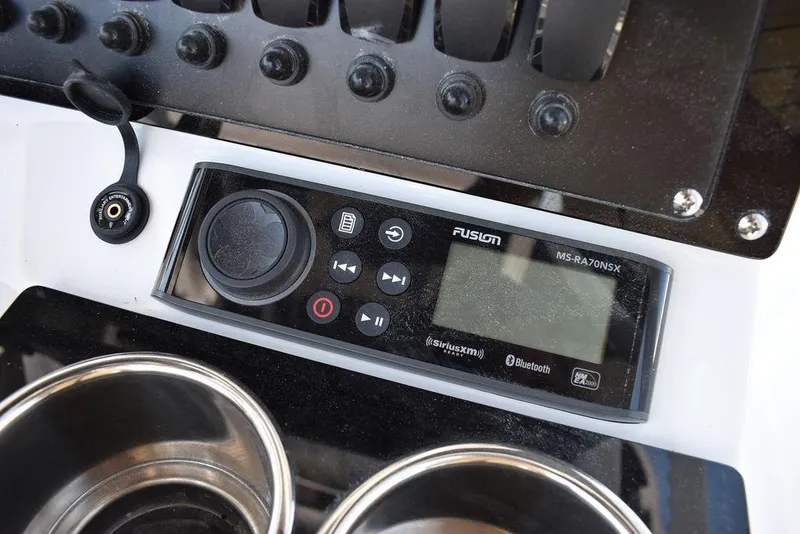 Slide: The Image of 2023 Blackfin 252CC boat dashboard with Fusion MS-RA70NSX stereo system. - 34