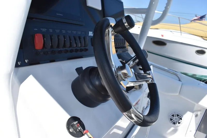 Slide: The Image of Close-up of the steering wheel and control panel of a 2023 Blackfin 252CC boat. - 36