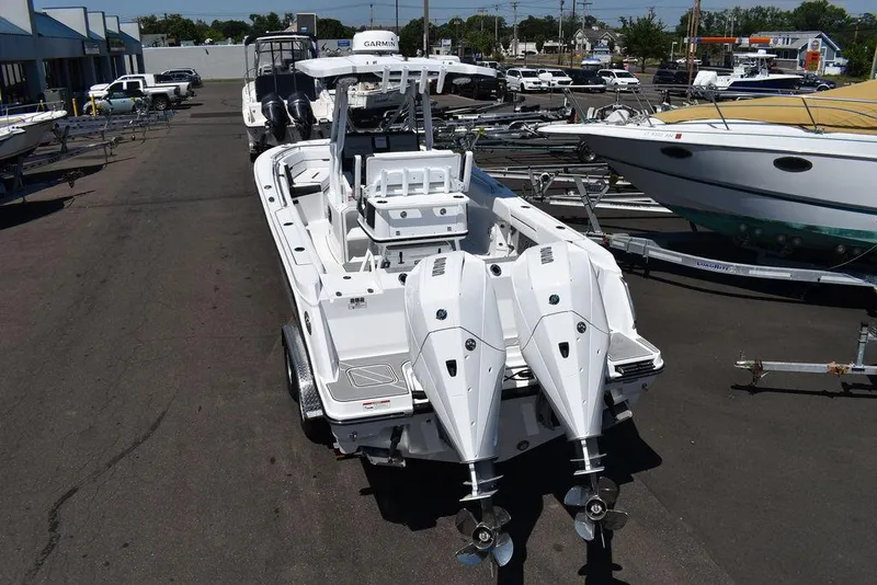 Slide: The Image of 2023 Blackfin 252CC boat with dual outboard engines in a marina. - 4
