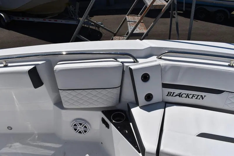 Slide: The Image of 2023 Blackfin 252CC boat interior with white seating and cup holder. - 48