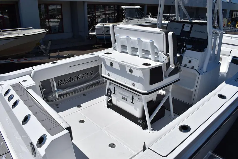 Slide: The Image of 2023 Blackfin 252CC center console boat interior with fishing rod holders and storage compartments. - 7