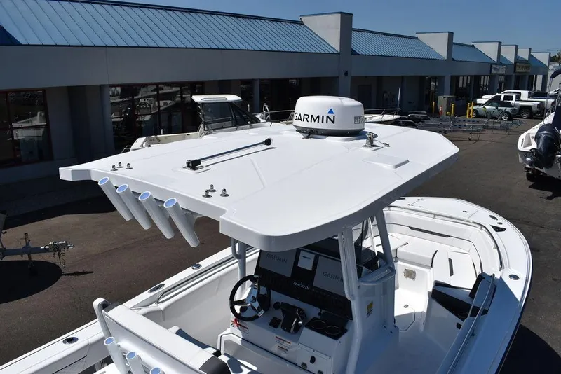 Slide: The Image of 2023 Blackfin 252CC boat with Garmin radar, docked at a marina. - 9