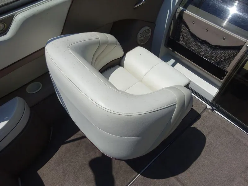 Slide: The Image of 1999 Cobalt 253 boat interior with white leather seating. - 12