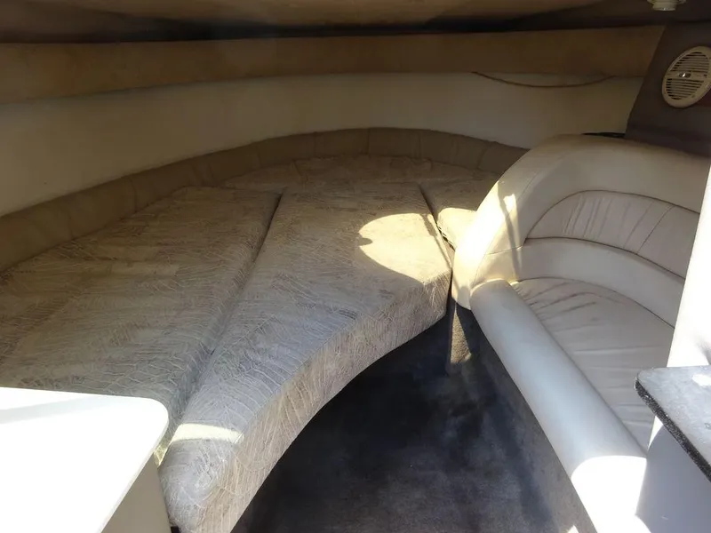 Slide: The Image of Interior cabin of a 1999 Cobalt 253 boat with beige seating and bedding. - 15