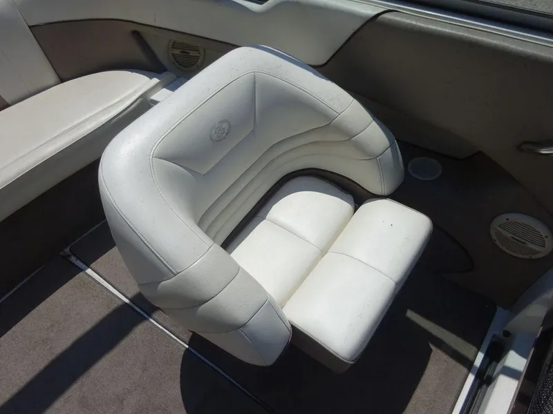 Slide: The Image of White leather seat in a 1999 Cobalt 253 boat interior. - 18