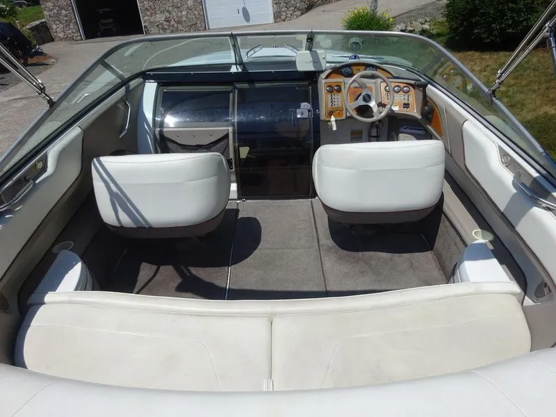 Slide: The Image of 1999 Cobalt 253 boat interior with white seats and dashboard. - 5