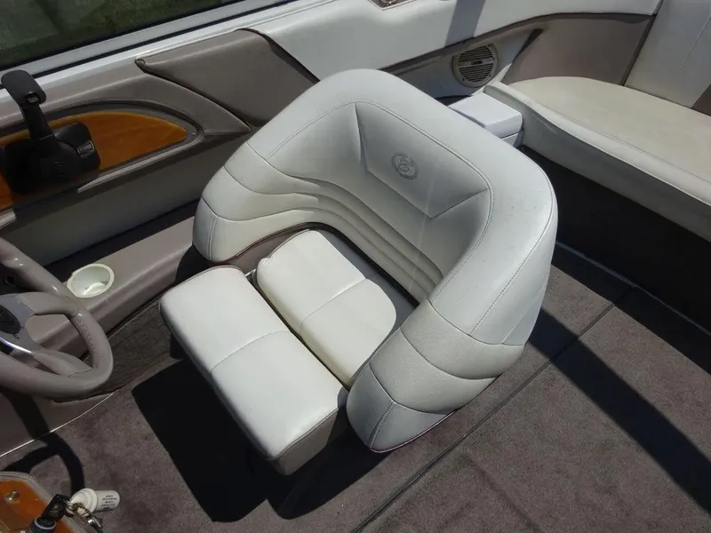 Slide: The Image of 1999 Cobalt 253 boat interior with white leather captain's chair and wood accents. - 6