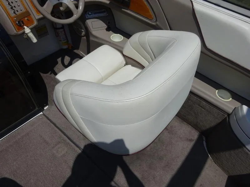 Slide: The Image of 1999 Cobalt 253 boat interior with white leather seat and steering wheel. - 7