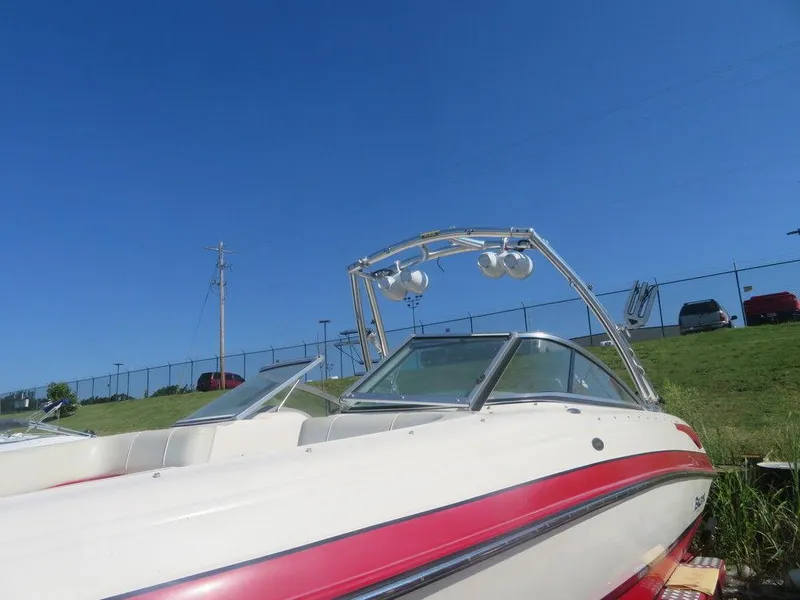 Slide: The Image of 2012 Bryant 246 boat with red and white exterior on a sunny day. - 11
