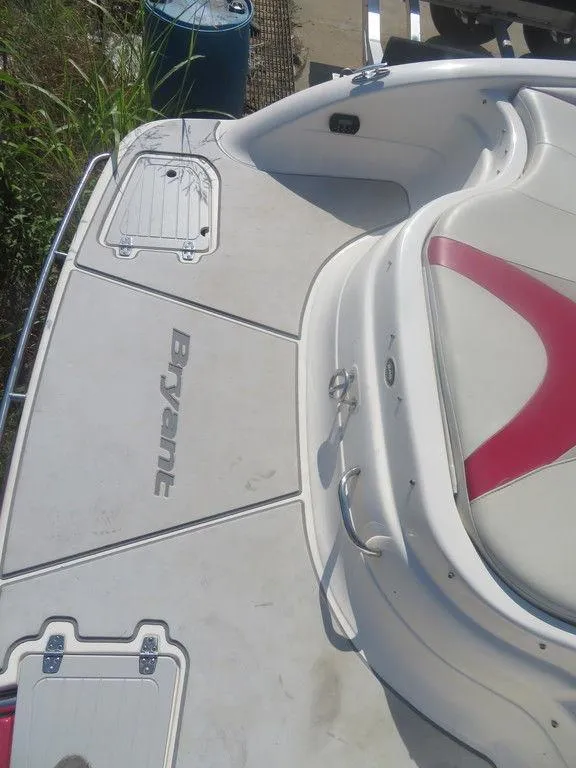 Slide: The Image of 2012 Bryant 246 boat deck with seating and storage compartments. - 13