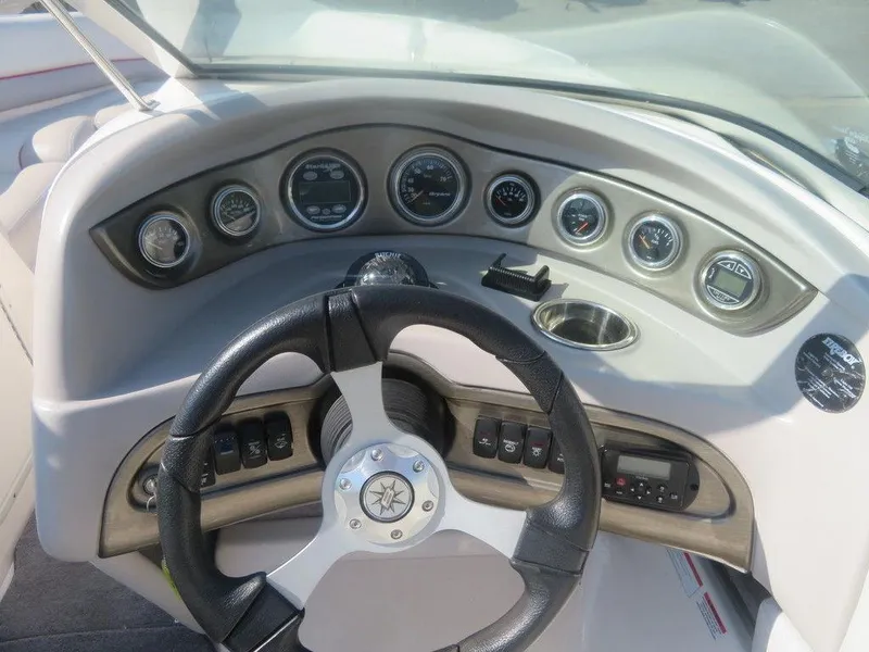 Slide: The Image of 2012 Bryant 246 boat dashboard with steering wheel and gauges. - 3