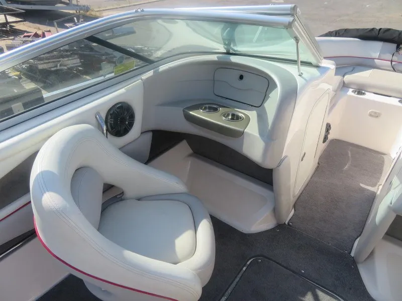 Slide: The Image of Interior of a 2012 Bryant 246 boat with white seating and cup holders. - 4