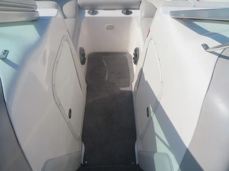 Slide: The Image of Interior of a 2012 Bryant 246 boat with carpeted flooring and storage compartments. - 5