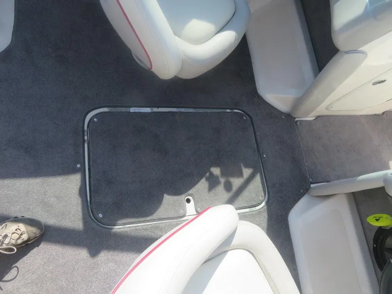 Slide: The Image of Interior of a 2012 Bryant 246 boat showing seating and floor compartment. - 6