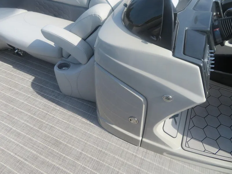 Slide: The Image of 2020 Xcursion 245 Sport Toon boat interior with gray seating and console. - 13