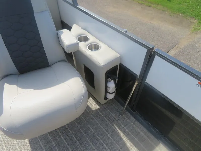 Slide: The Image of 2020 Xcursion 245 Sport Toon boat interior with seat, cup holders, and fire extinguisher. - 14