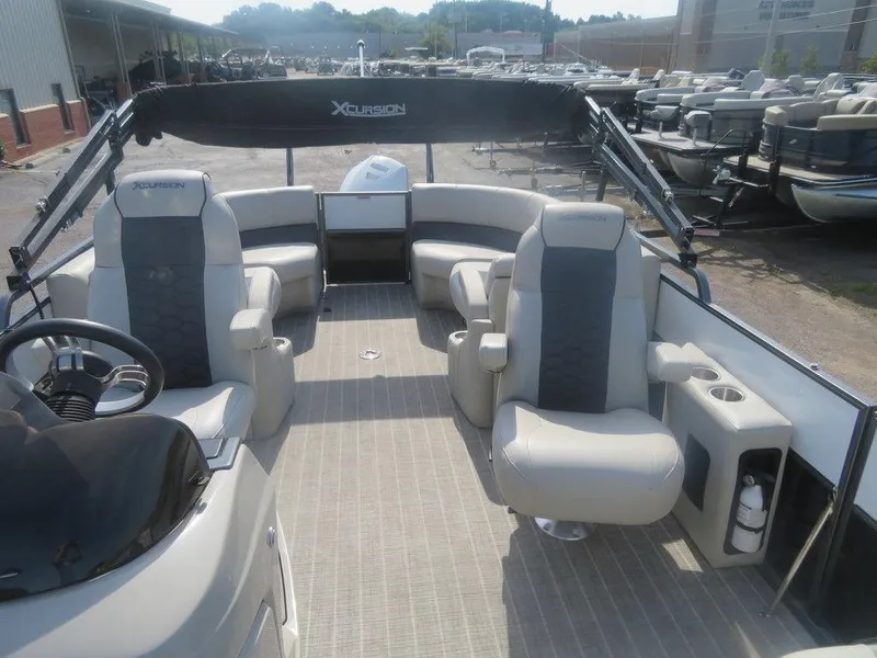 Slide: The Image of 2020 Xcursion 245 Sport Toon boat interior with seating and steering console. - 15