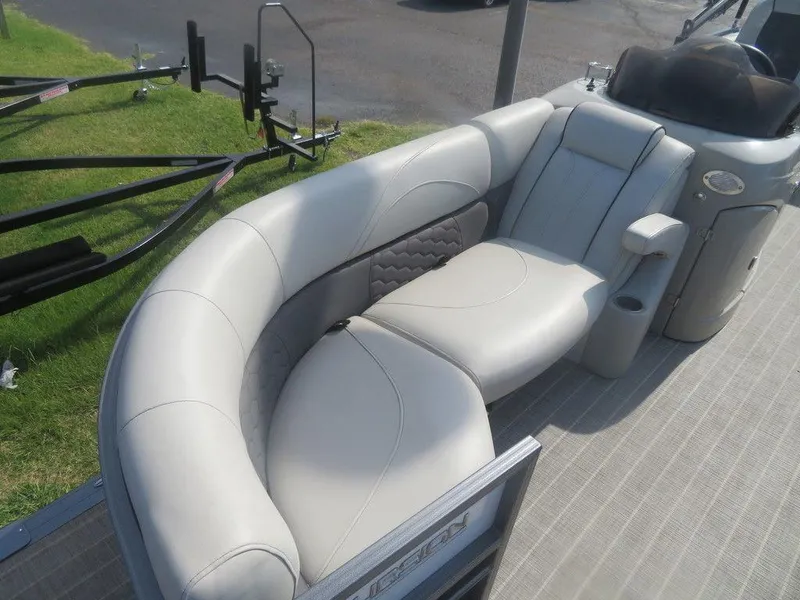Slide: The Image of 2020 Xcursion 245 Sport Toon boat interior with plush seating and trailer. - 16