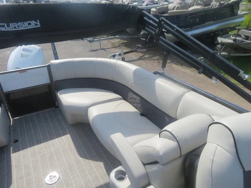 Slide: The Image of 2020 Xcursion 245 Sport Toon boat with trailer, featuring spacious seating. - 5