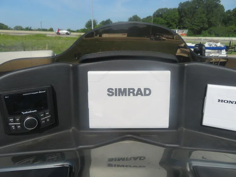 Slide: The Image of Dashboard of a 2020 Xcursion 245 Sport Toon boat with Simrad electronics. - 6