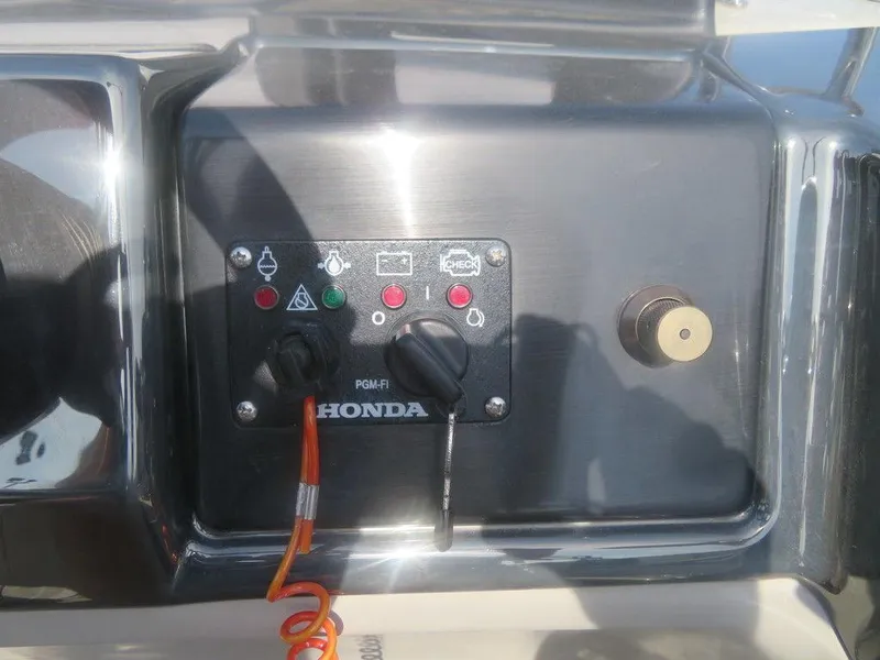 Slide: The Image of Control panel of a 2020 Xcursion 245 Sport Toon boat with Honda engine. - 7