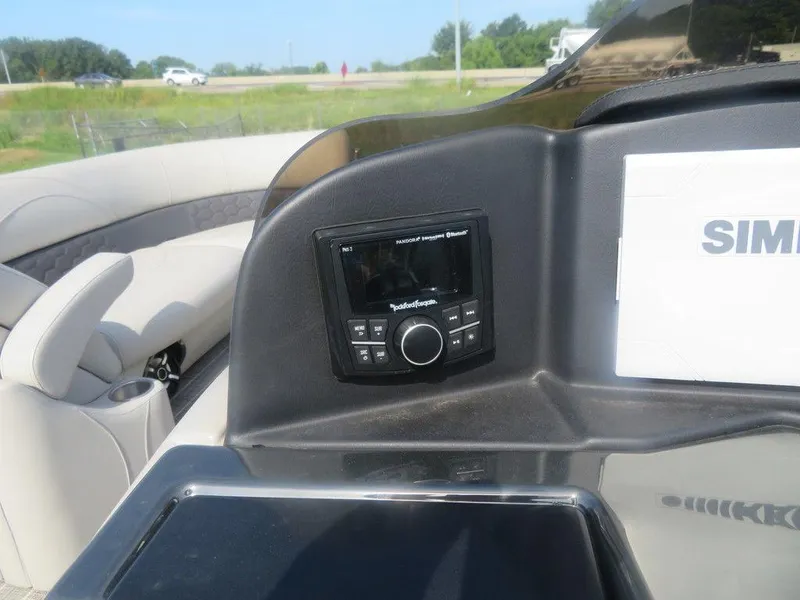 Slide: The Image of Control panel of a 2020 Xcursion 245 Sport Toon boat with a Rockford Fosgate stereo. - 8
