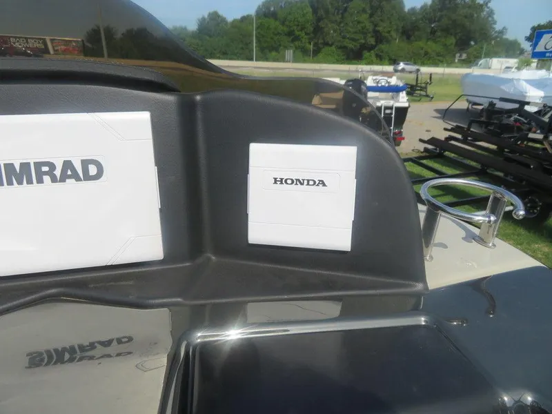 Slide: The Image of 2020 Xcursion 245 Sport Toon boat dashboard with Honda and Simrad equipment. - 9