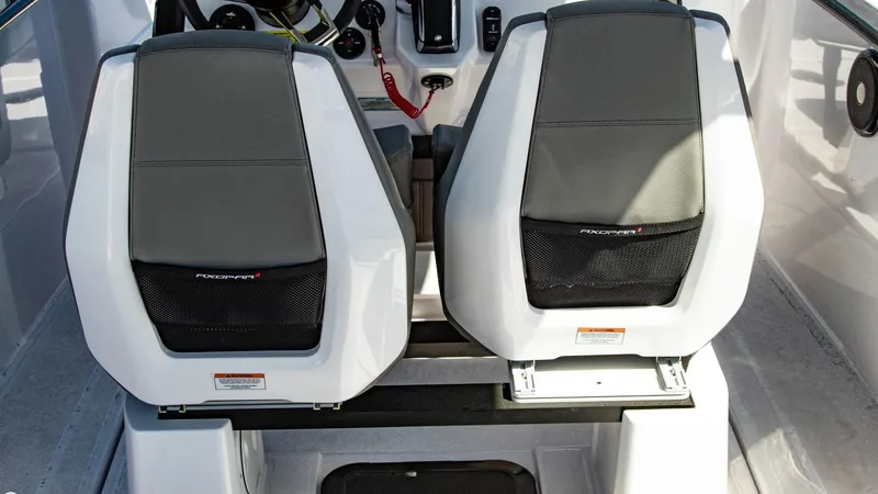 Slide: The Image of 2023 Axopar 22 T-Top boat interior with dual seats and control panel. - 13