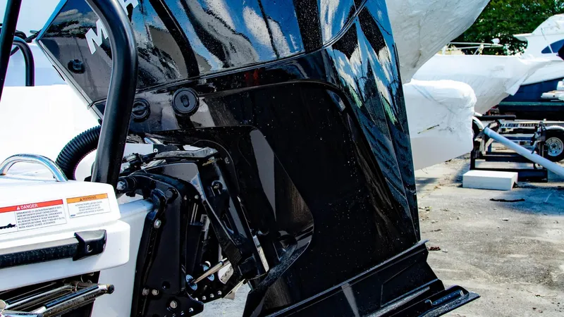 Slide: The Image of 2023 Axopar 22 T-Top boat engine close-up in a marina. - 15