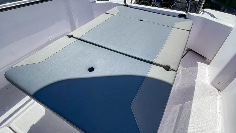 Slide: The Image of 2023 Axopar 22 T-Top boat with cushioned seating area. - 5