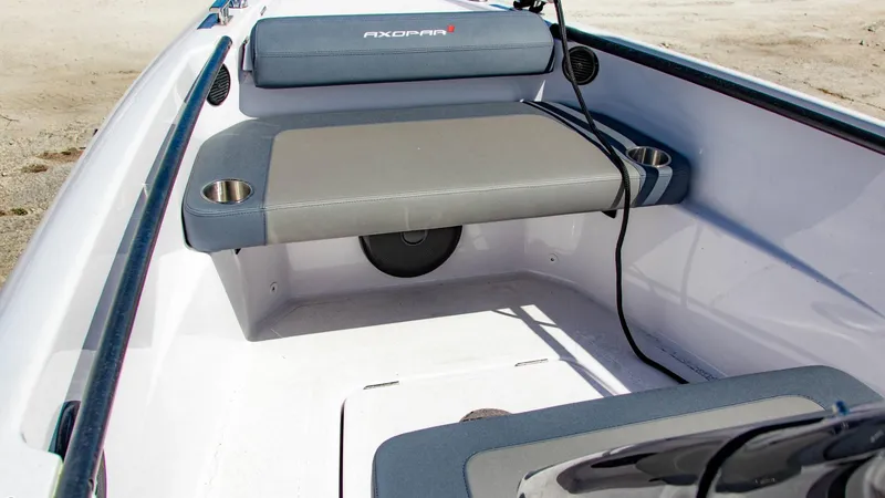 Slide: The Image of 2023 Axopar 22 T-Top boat interior with cushioned seating and cup holders. - 6