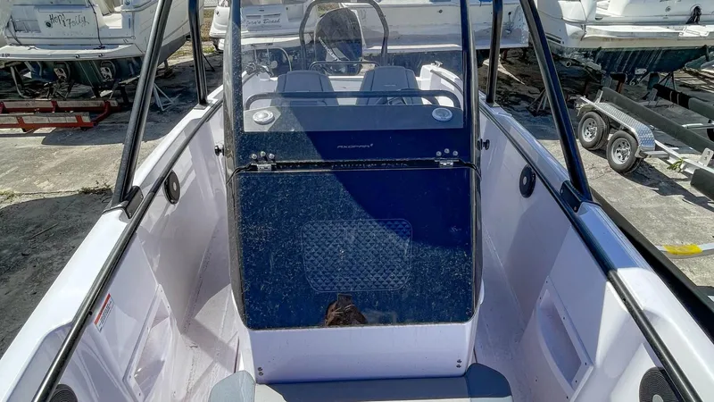 Slide: The Image of 2023 Axopar 22 T-Top boat interior with steering console and seating. - 8