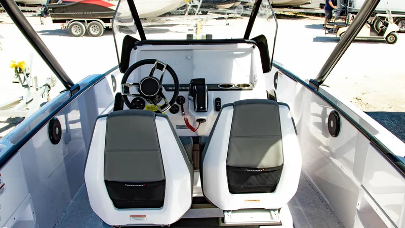 Slide: The Image of 2023 Axopar 22 T-Top boat interior with dual seats and steering console. - 9