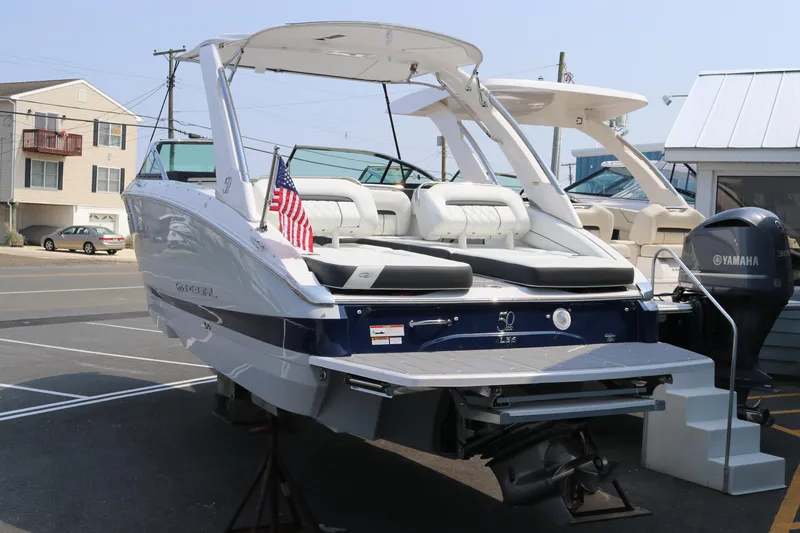 Slide: The Image of 2023 Regal LS6 boat with Yamaha engine, docked in a marina, featuring a sleek design. - 3