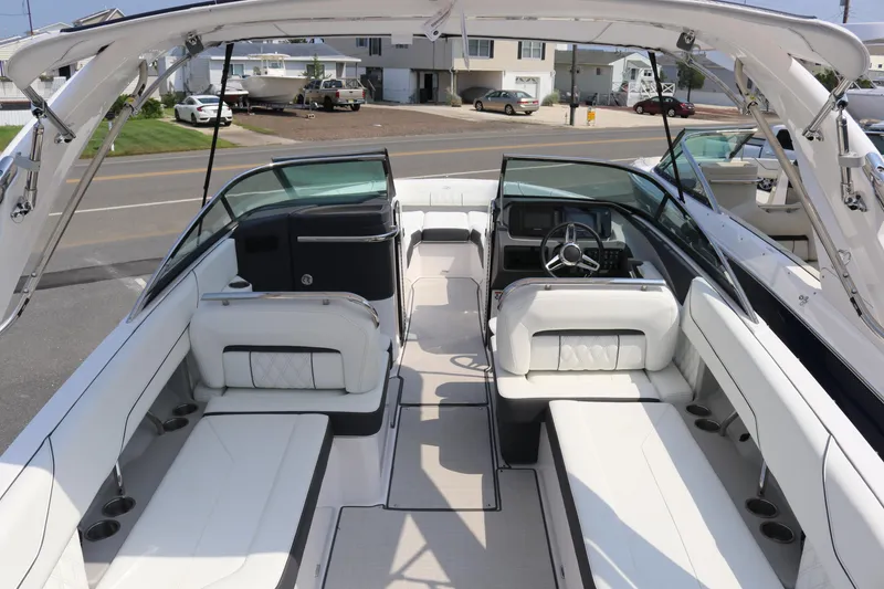 Slide: The Image of 2023 Regal LS6 boat interior with white seating and modern dashboard design. - 5