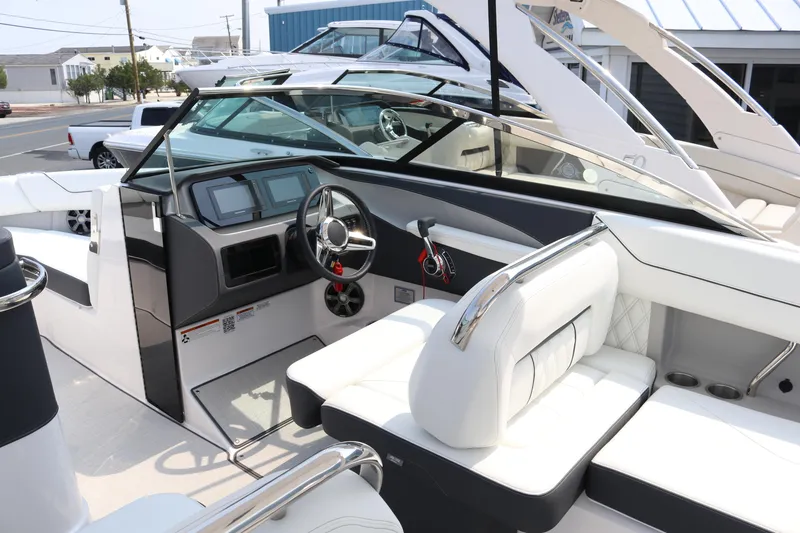 Slide: The Image of 2023 Regal LS6 boat interior with modern dashboard and white seating. - 6